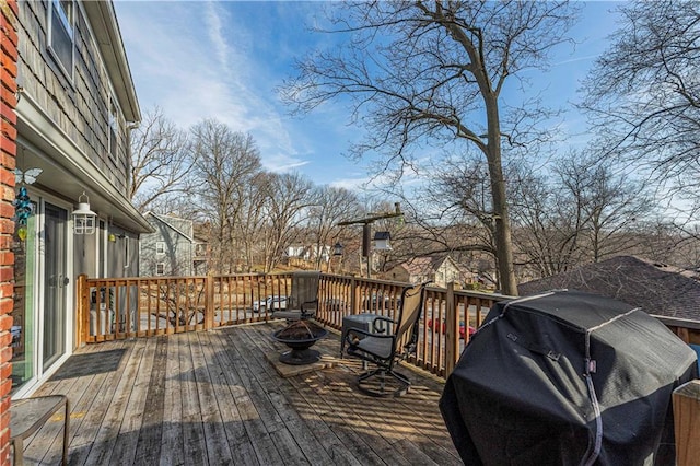 deck featuring a fire pit and grilling area