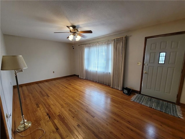 entrance foyer featuring hardwood / wood-style floors, a textured ceiling, and ceiling fan