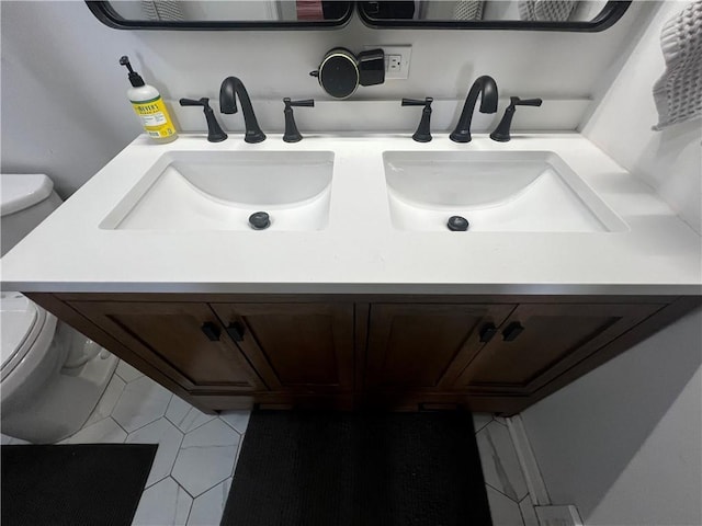 bathroom featuring vanity and toilet