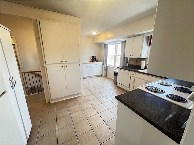 kitchen with light tile patterned floors, white appliances, decorative backsplash, and white cabinets