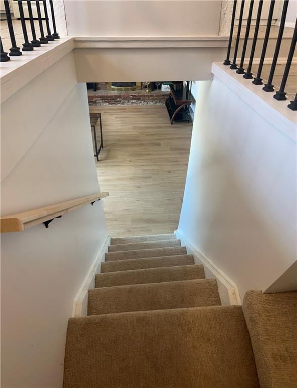 staircase with hardwood / wood-style floors