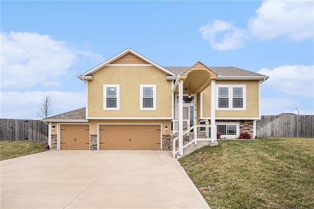 split foyer home featuring a garage and a front lawn