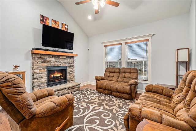 living room with a stone fireplace, vaulted ceiling, ceiling fan, and hardwood / wood-style flooring