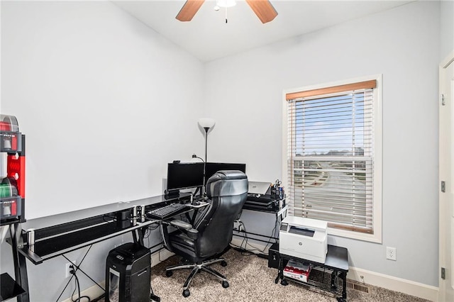 carpeted office space featuring ceiling fan