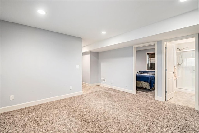 basement featuring light colored carpet