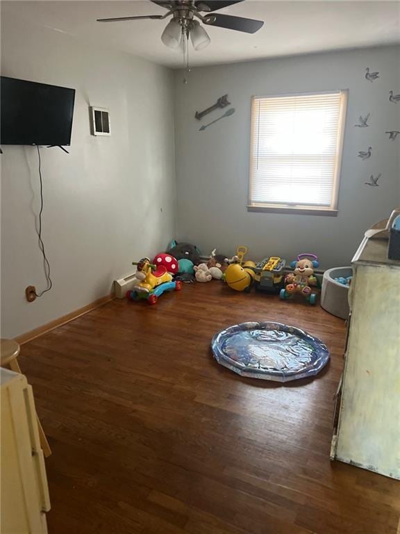 interior space featuring dark wood-type flooring and ceiling fan