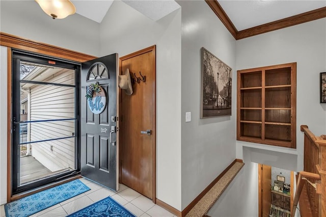 foyer featuring light tile patterned floors, baseboards, and crown molding