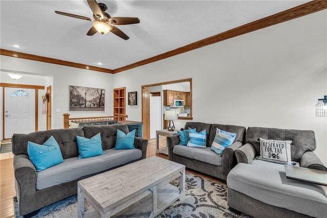 living room with ceiling fan, ornamental molding, wood finished floors, and recessed lighting