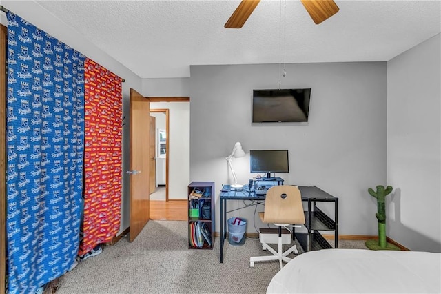 bedroom with carpet floors, ceiling fan, a textured ceiling, and baseboards