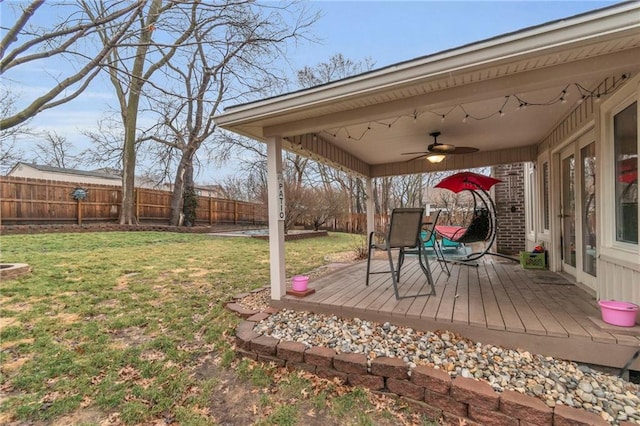 view of yard featuring a wooden deck, a fenced backyard, and a ceiling fan