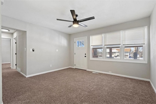 unfurnished room with ceiling fan and carpet flooring