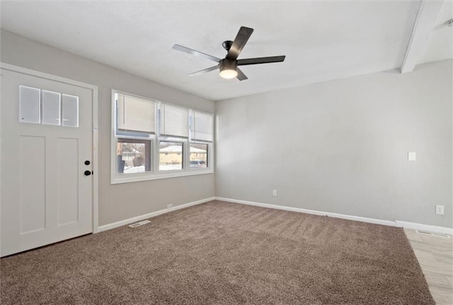 empty room featuring light colored carpet and ceiling fan