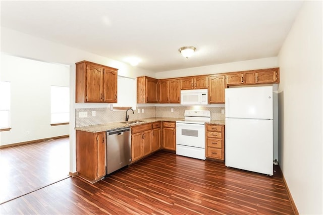 kitchen with white appliances, dark hardwood / wood-style flooring, sink, and decorative backsplash