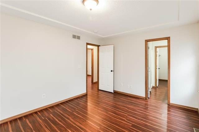 empty room with dark hardwood / wood-style floors