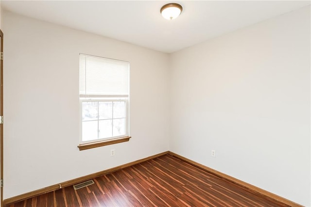 unfurnished room featuring dark wood-type flooring