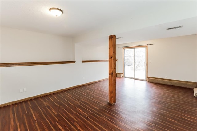 unfurnished room with dark hardwood / wood-style flooring