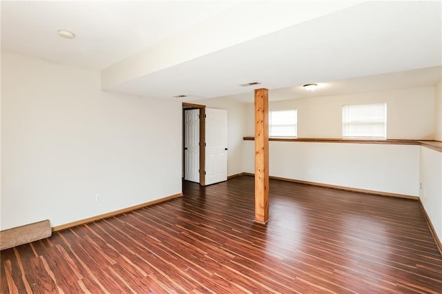 basement with dark hardwood / wood-style floors