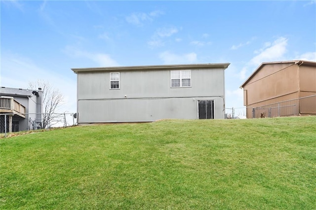 rear view of property with a yard