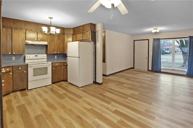 kitchen with ceiling fan with notable chandelier, white appliances, light hardwood / wood-style floors, and hanging light fixtures