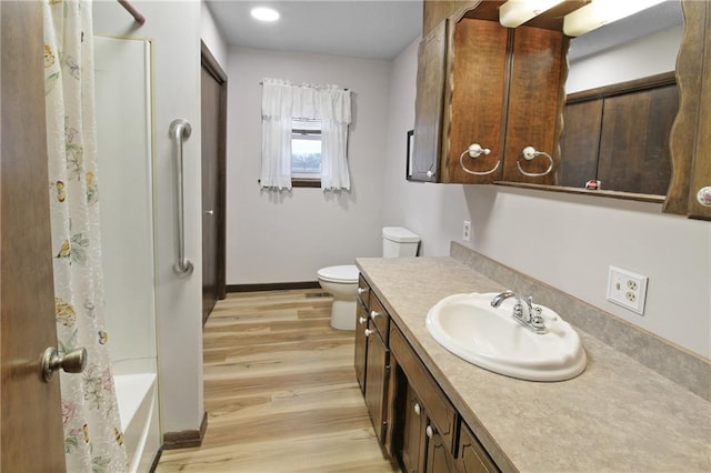 full bathroom featuring shower / bathtub combination with curtain, wood-type flooring, toilet, and vanity