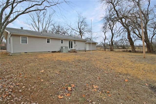 back of house with central air condition unit