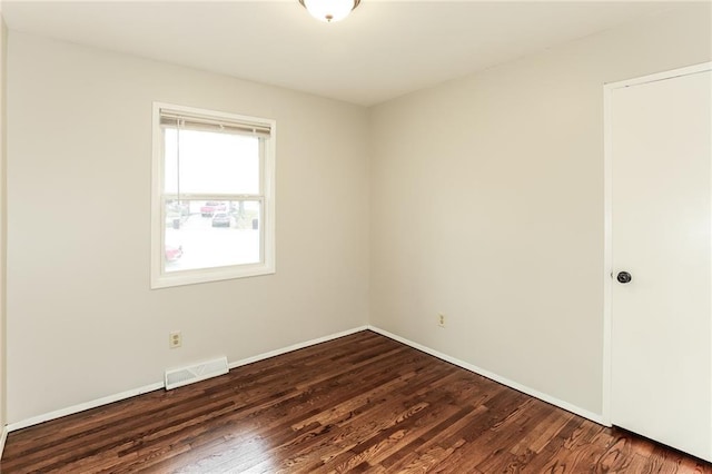 empty room with dark wood-type flooring