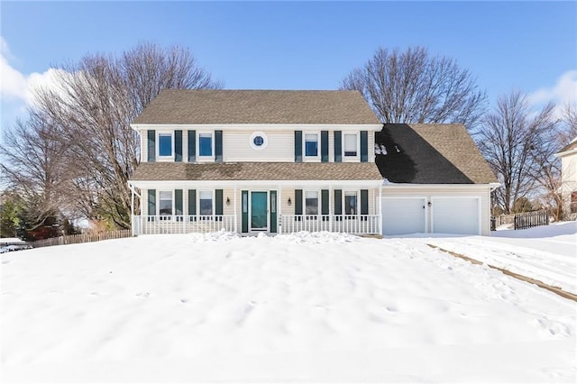 colonial house with a garage and covered porch