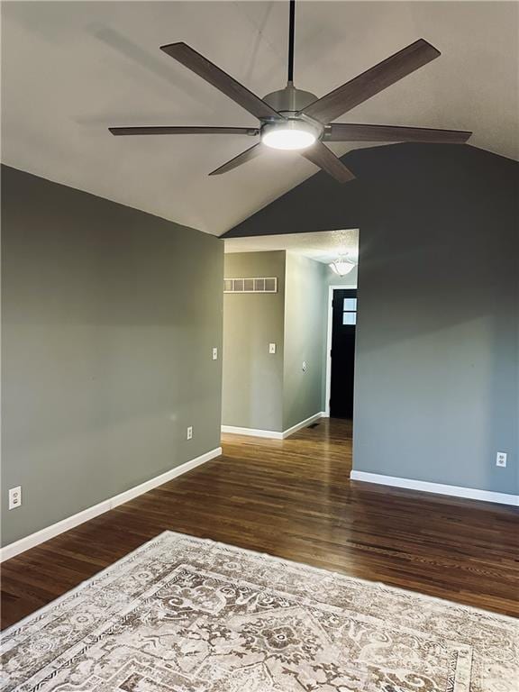 unfurnished room with dark hardwood / wood-style flooring, vaulted ceiling, and ceiling fan