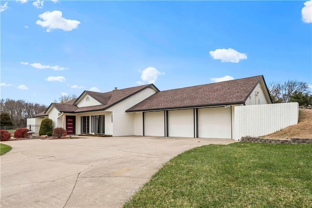 single story home featuring an attached garage, fence, a front lawn, and concrete driveway