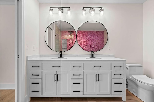 bathroom featuring wood finished floors, a sink, and double vanity