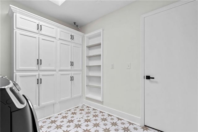 walk in closet with light floors