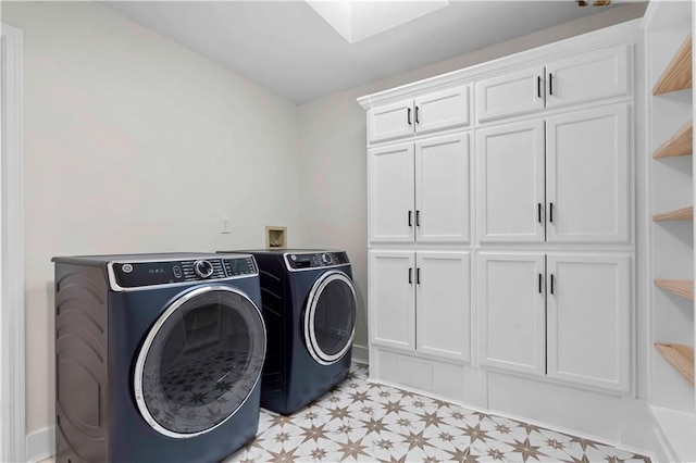 laundry room with light floors, cabinet space, and washer and dryer