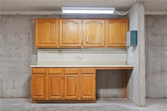 kitchen featuring concrete floors and brown cabinets