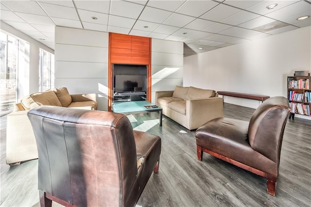 living room with a paneled ceiling and light hardwood / wood-style flooring