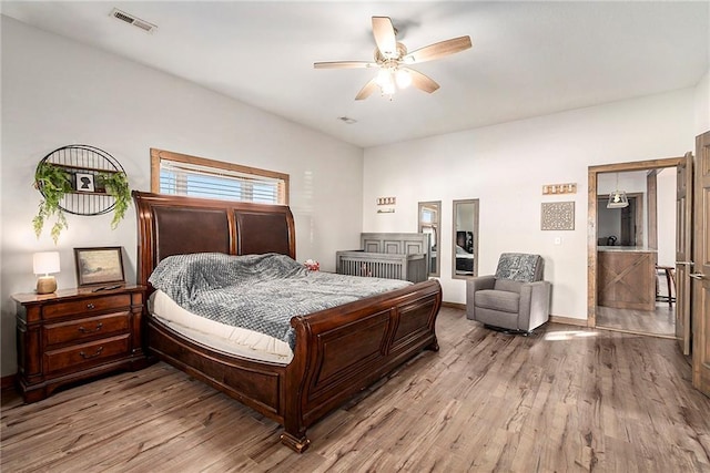 bedroom with ceiling fan and light hardwood / wood-style flooring