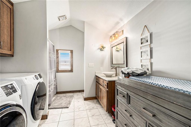 interior space featuring vaulted ceiling, vanity, and independent washer and dryer