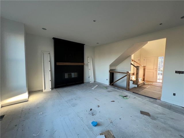 unfurnished living room featuring a fireplace