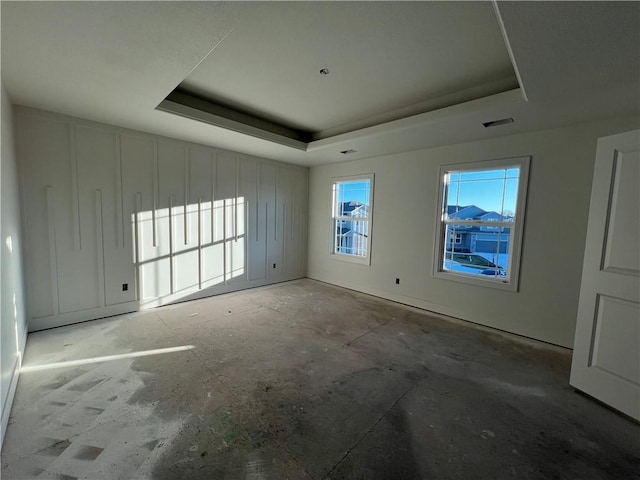 spare room with a raised ceiling