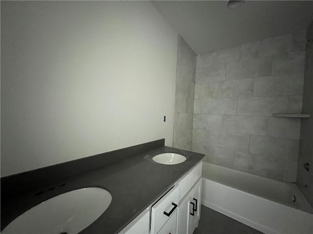 bathroom with vanity and a washtub