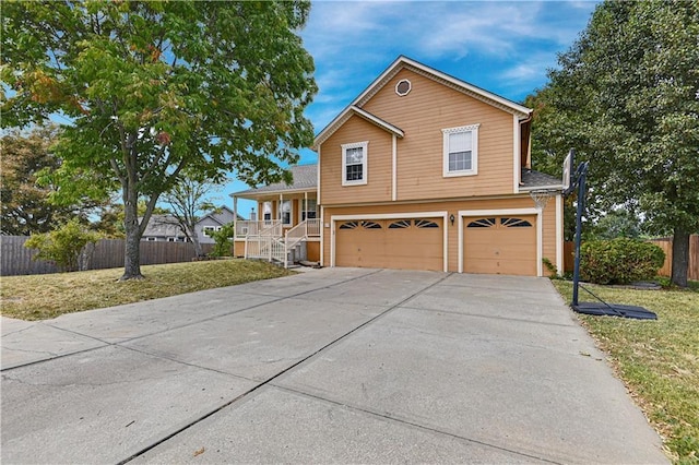 view of front facade featuring a porch, a garage, and a front yard