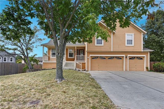 tri-level home with a garage, a front lawn, and a porch