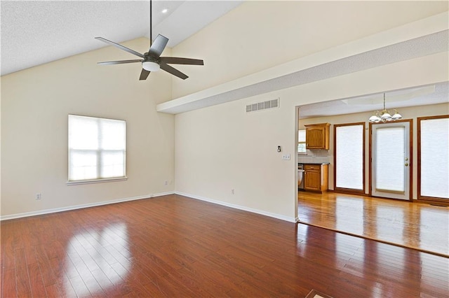 unfurnished living room with wood-type flooring, ceiling fan, and vaulted ceiling