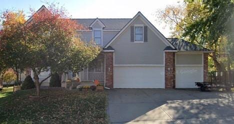 1409 NE 94th St, Kansas City, MO 64155 - traditional home featuring driveway and brick siding
