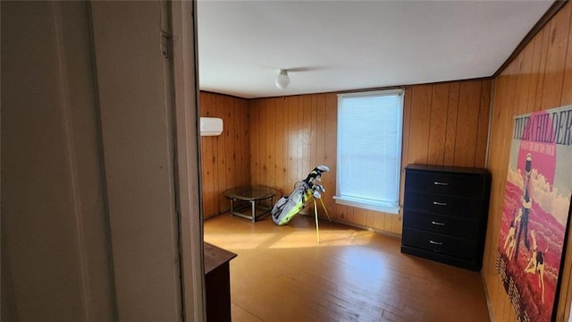 miscellaneous room featuring light hardwood / wood-style flooring and wood walls