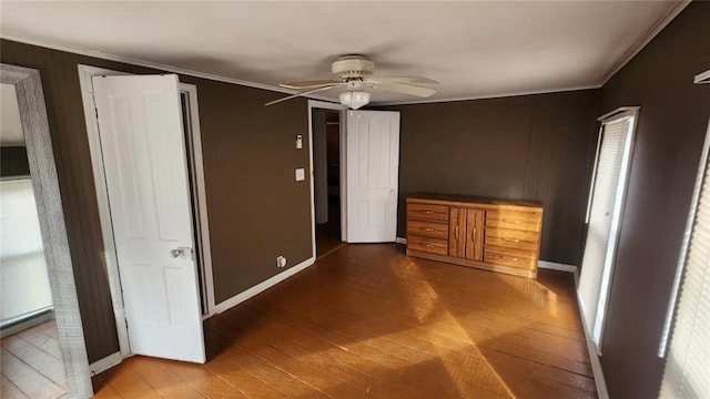 unfurnished bedroom with crown molding, wood-type flooring, and ceiling fan