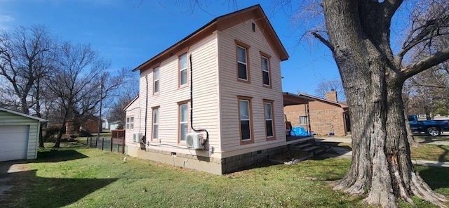 view of side of home featuring crawl space and a yard