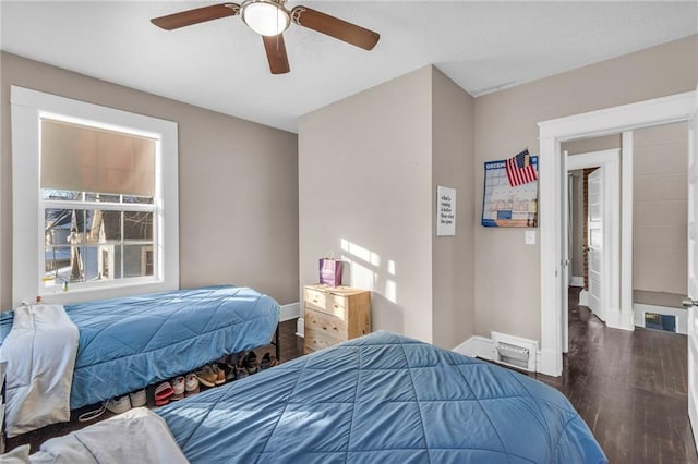 bedroom with dark hardwood / wood-style floors and ceiling fan