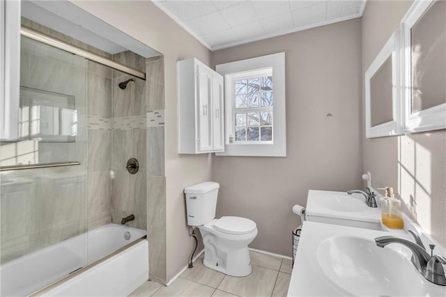 full bathroom featuring enclosed tub / shower combo, vanity, tile patterned floors, and toilet