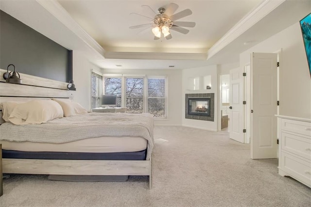 bedroom with ceiling fan, a multi sided fireplace, a raised ceiling, and light carpet