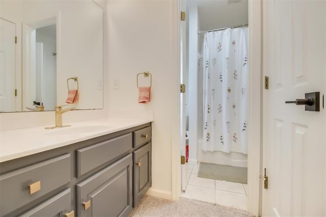 bathroom with tile patterned flooring, vanity, and shower / tub combo with curtain